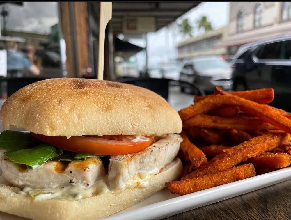Grilled mahimahi sandwich on ciabatta with sweet potato fries.